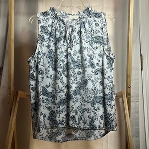 Floral tank top with draw sting around neck line area and flowy bottom.